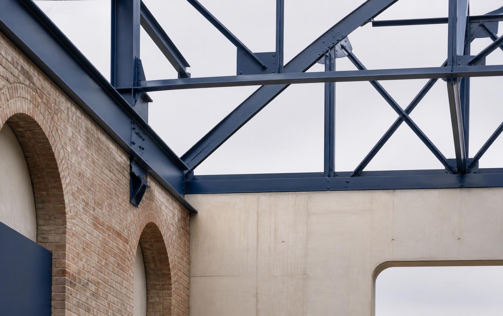 Blue steelwork and brick arches reflecting the Midlands' industrial heritage